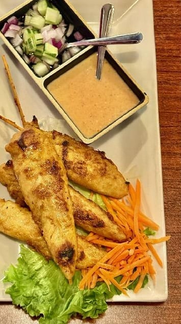 Grilled chicken satay with peanut sauce and cucumber salad